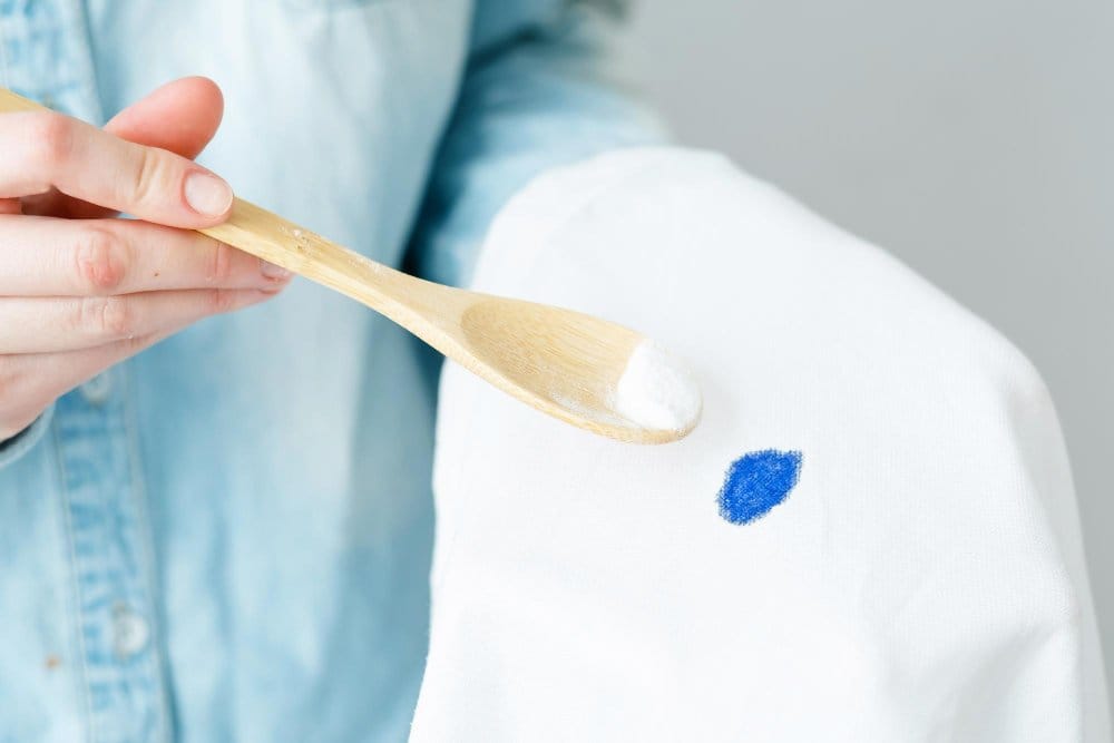 A woman removing stain on a clothe