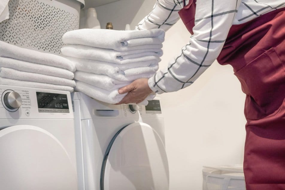 Handling towels and other laundry near a tumble dryer