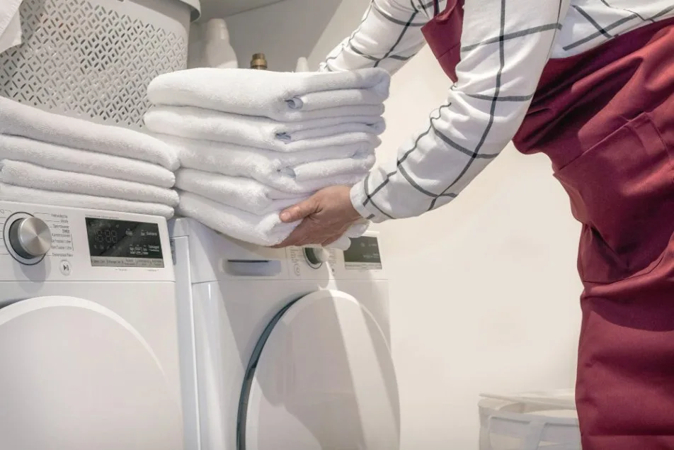 Handling towels and other laundry near a tumble dryer