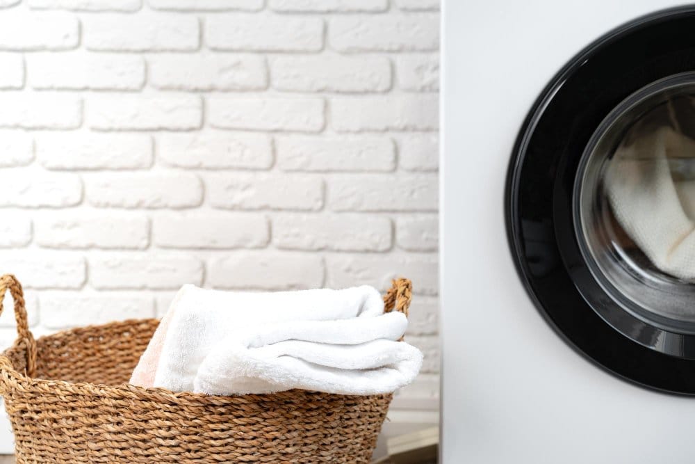 laundry basket placed beside a tumble dryer