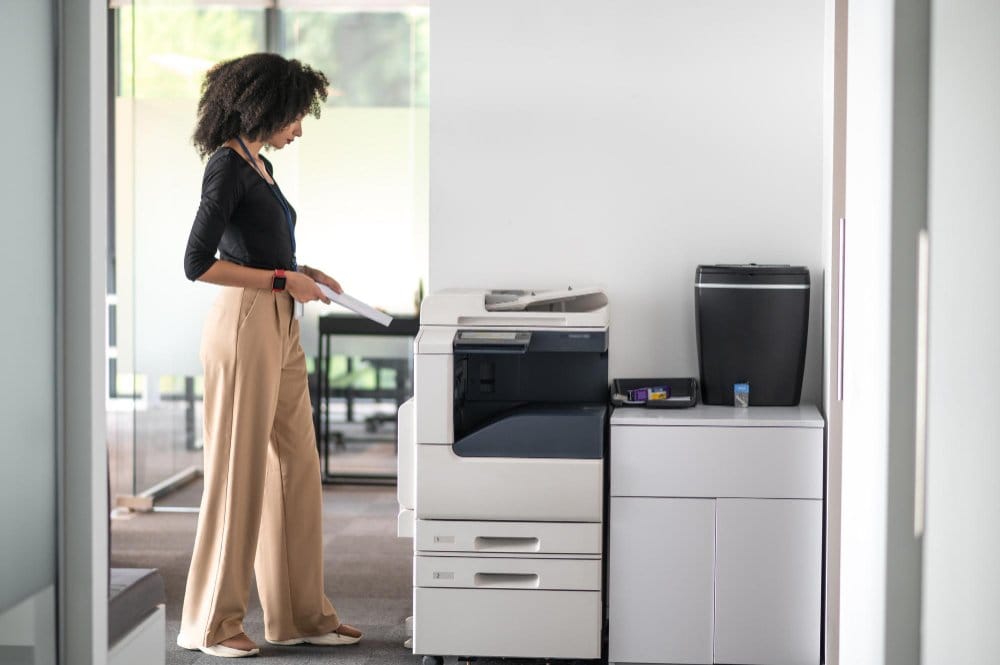 woman standing in front of a printer