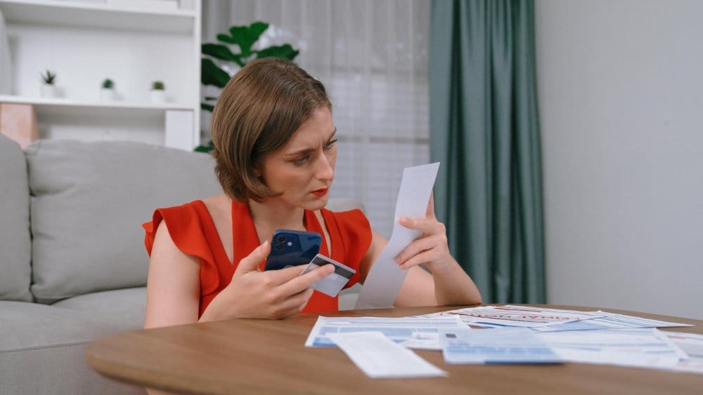 A woman calculating fees and payouts