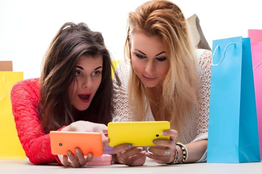 Two shoppers looking surprised at deals while comparing resale platforms