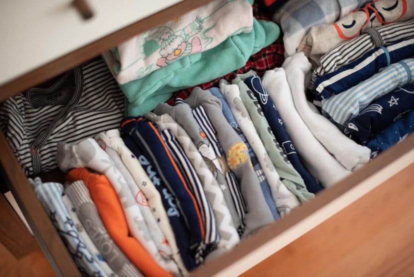 toddler clothes neatly folded and organized in a drawer