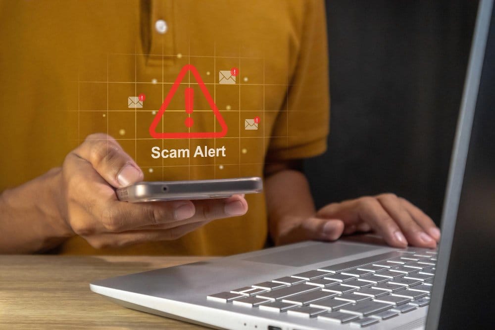 Phone displaying scam alert warning during online transaction