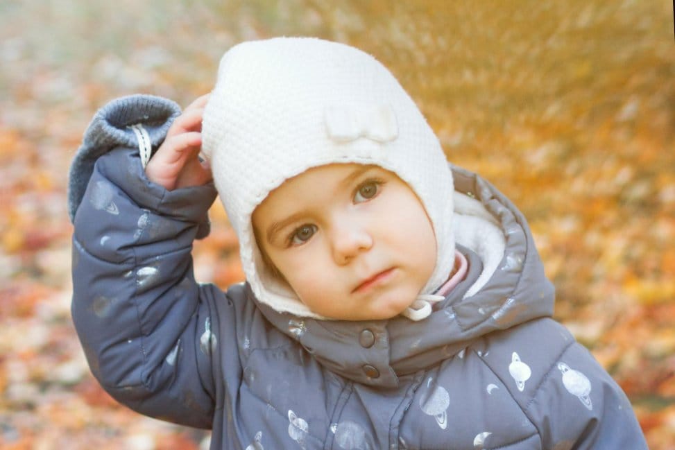Toddler wearing warm jacket outdoors in autumn weather