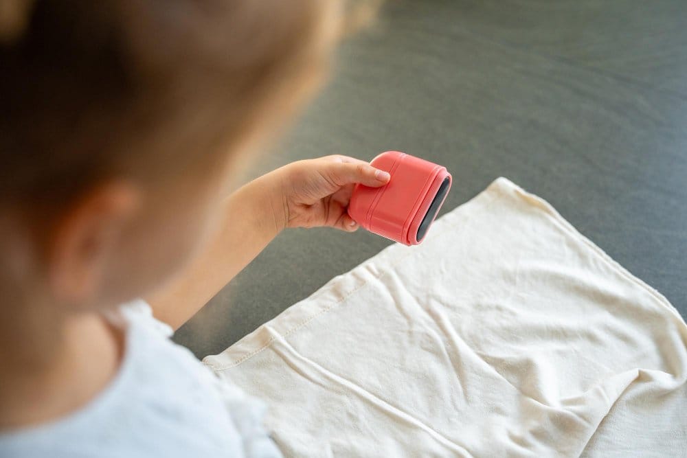 Applying stain remover to light colored toddler shirt