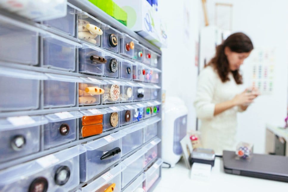 Drawer system filled with sorted clothing and accessories for resale inventory