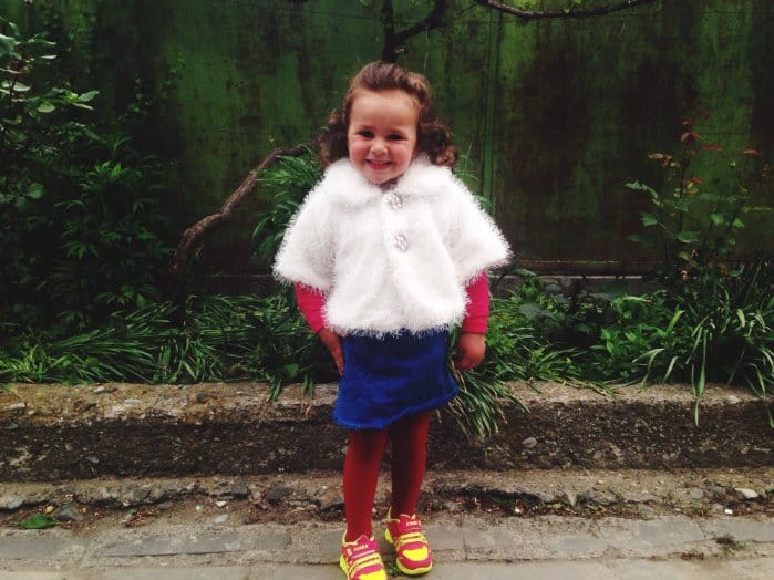 Happy little girl wearing mismatch clothes