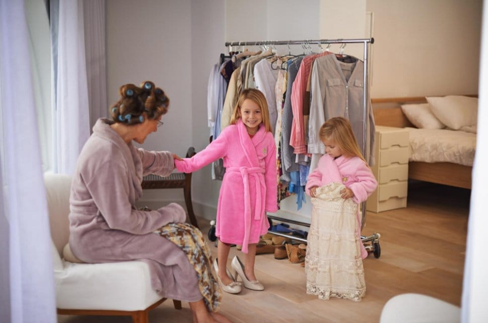 Mother and her two daughters having a dress-up fun