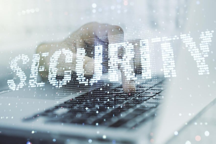 A close-up of a person's hand typing on a laptop keyboard with the word "SECURITY" displayed prominently in digital-style text overlay, symbolizing cybersecurity and data protection on ebay and vinted