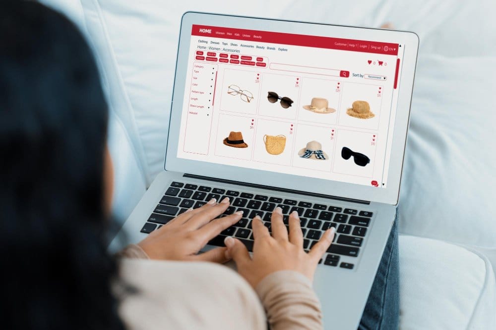 A woman sitting and using her laptop for checking other alternative to vinted and ebay