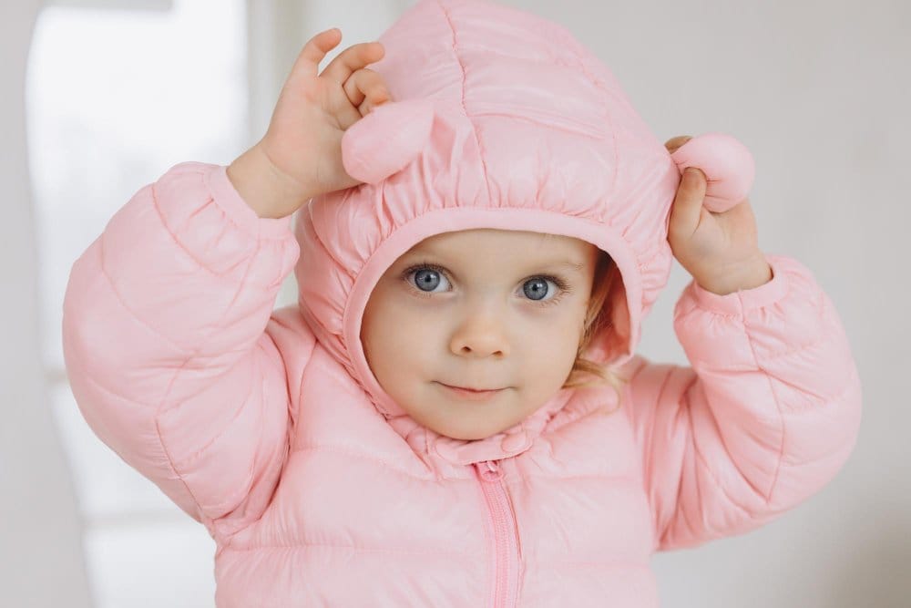 Close up of toddler wearing pink hooded jacket