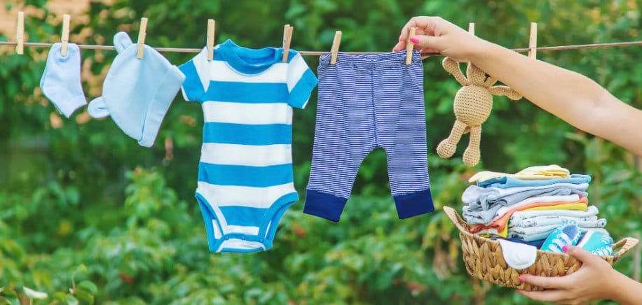 Toddler clothes hanging on a clothesline, drying in the sunlight