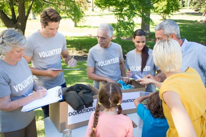 Happy community volunteers sorting donations
