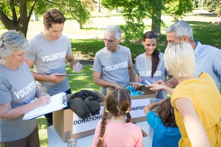 Community members working together at a clothing donation center, showing the positive impact of donations