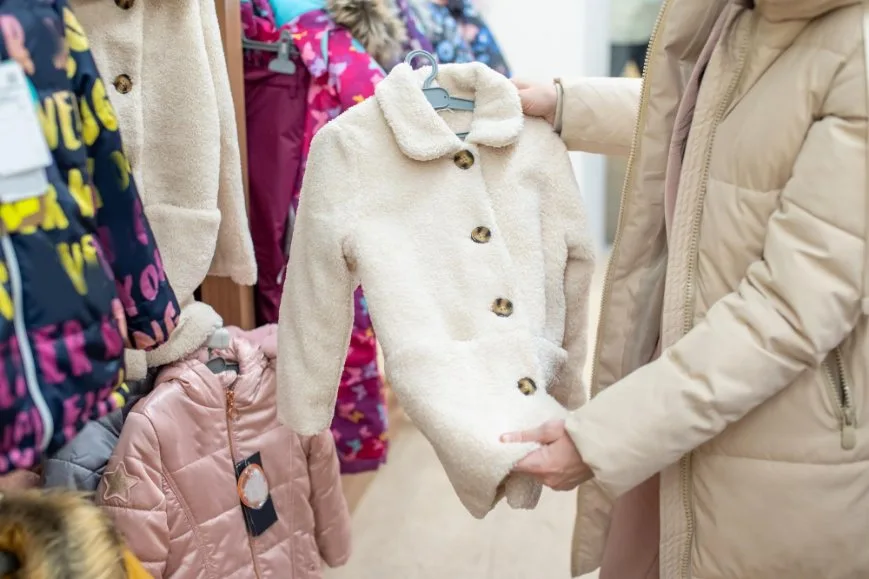A woman checking out a toddler coat