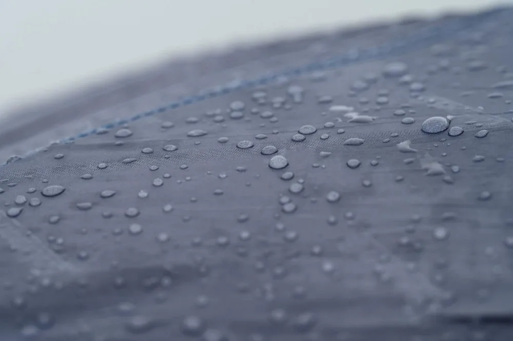 Fabric covered with many water droplets, representing durability of DWR finish