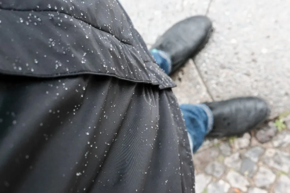 Rain speckled coat showing uneven repellency, example of common DWR issues