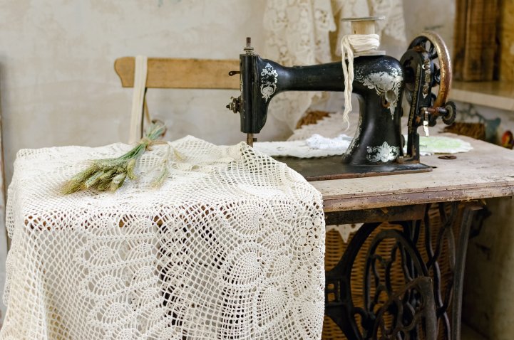 DIY craft workspace showing various knotted lace projects and crafting materials