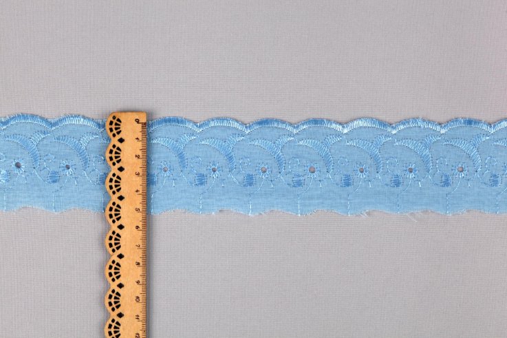 Various eyelet fabric projects including dresses, home decor items, and accessories