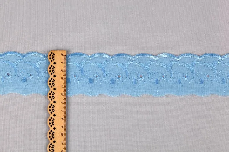 Various eyelet fabric projects including dresses, home decor items, and accessories