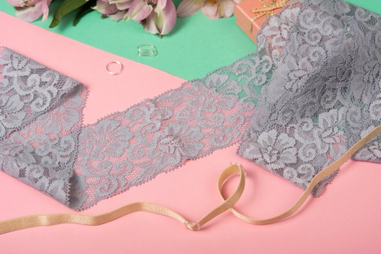 Close-up view of stretch lace fabric showing intricate patterns and elastic properties