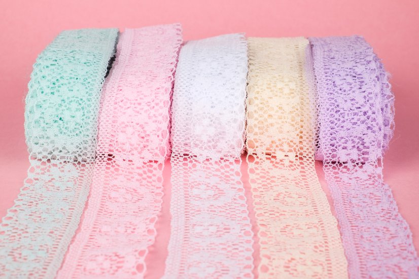Different types of lace hem tape and sewing alternatives displayed with sewing tools