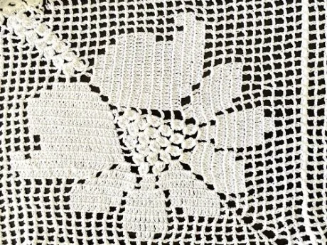 Examples of filet crochet patterns showing grid-based designs with filled and open squares