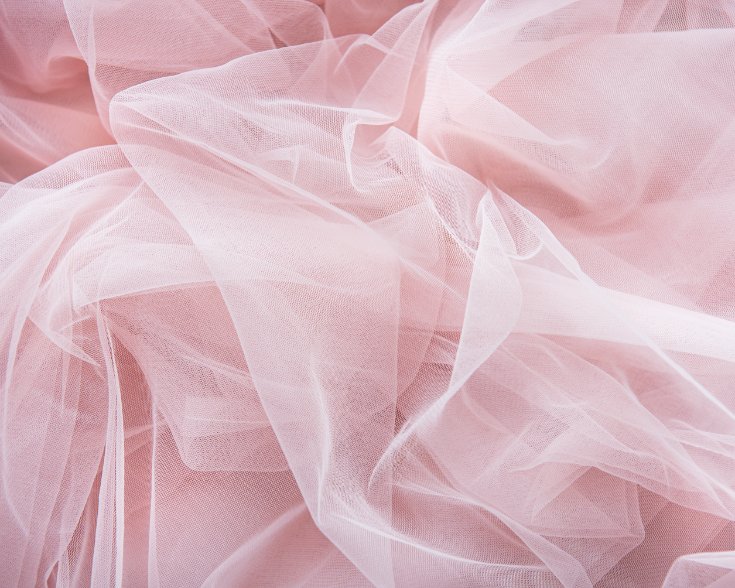 Close-up view of tulle fabric showing hexagonal mesh structure and fine netting texture
