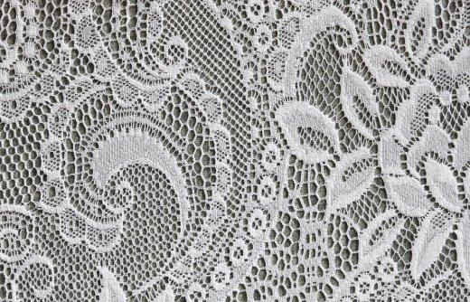 Close-up view of knotted lace fabric showing detailed construction and knot patterns