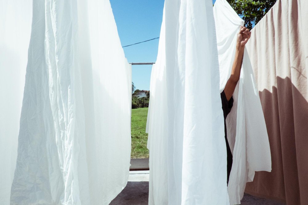 Step-by-step visual guide showing proper washing, drying, and ironing techniques for cotton poplin fabric care