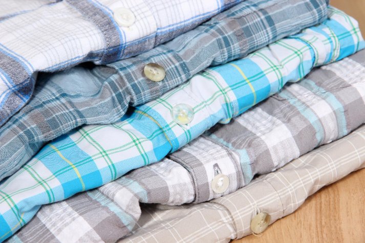 Flannel care setup showing washing machine, gentle detergent, and properly folded flannel garments demonstrating care techniques