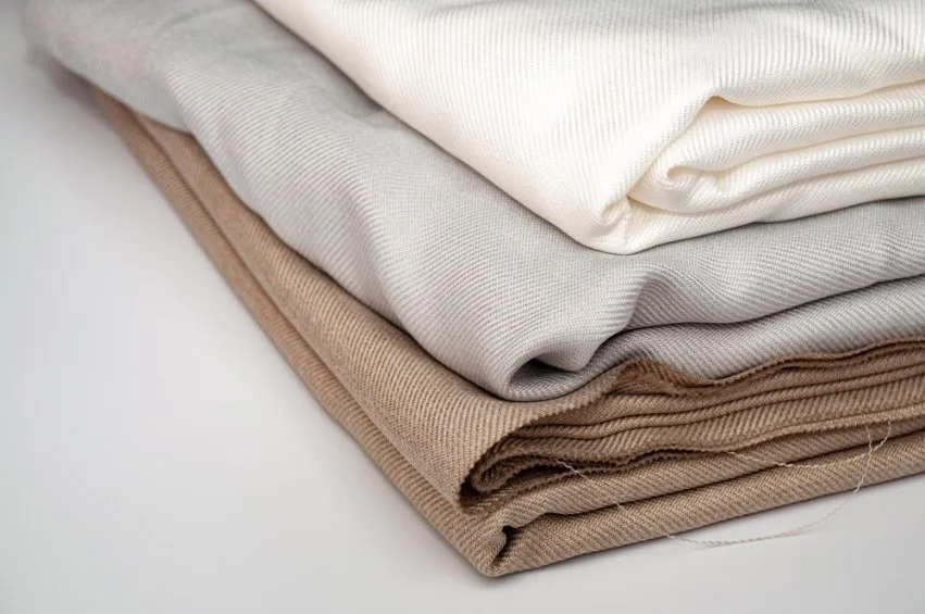 Step-by-step cotton twill fabric care process showing washing, drying, and ironing techniques