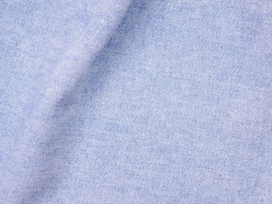 Close-up of light blue chambray cotton fabric.