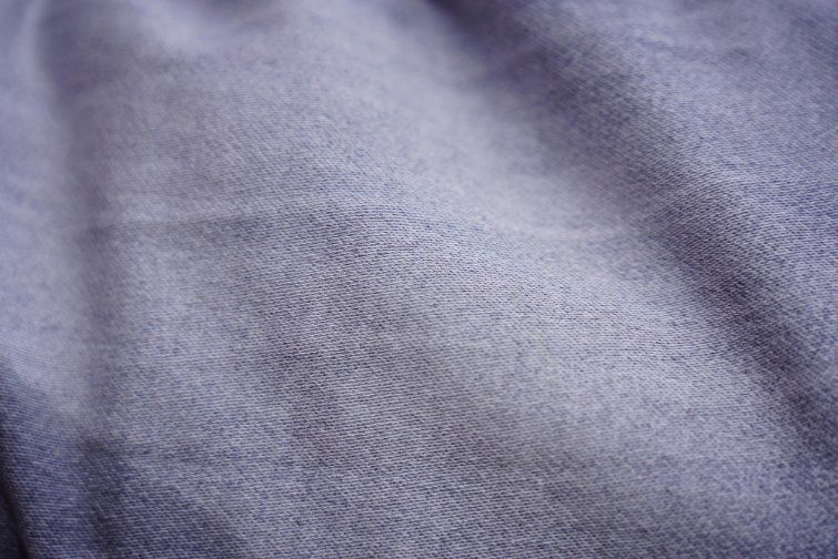 Gray cotton jersey fabric with a smooth knit surface.