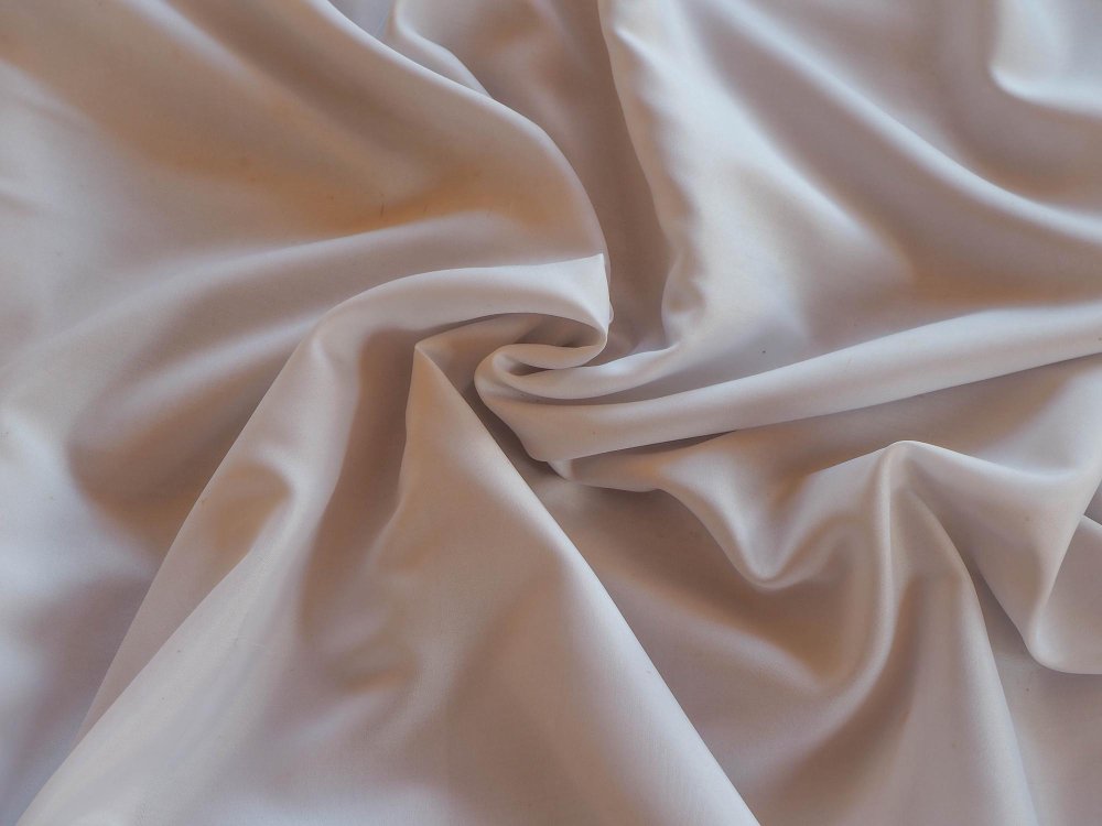 Draped white sateen fabric with a silky sheen.