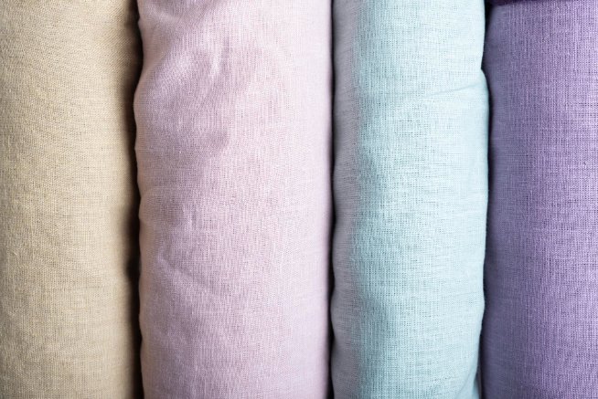 Visual comparison of different cotton fabric types including broadcloth, poplin, chambray, and twill showing weave patterns and textures