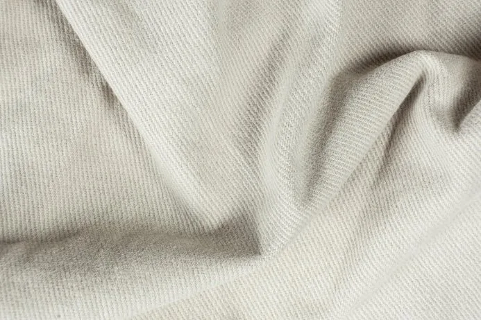 Close-up view of cotton twill fabric showing the distinctive diagonal weave pattern