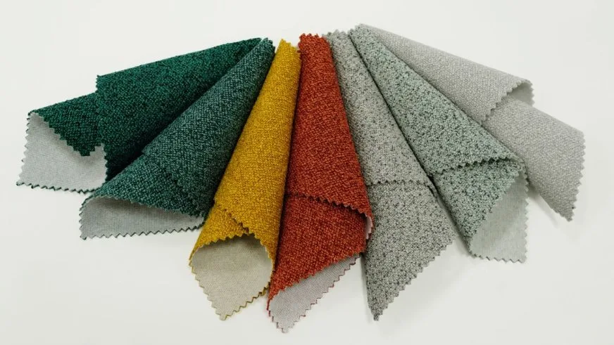 Different types of boucle fabric swatches showing various fiber blends and textures