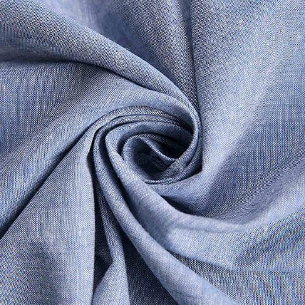 Chambray fabric displaying colored warp and white weft threads
