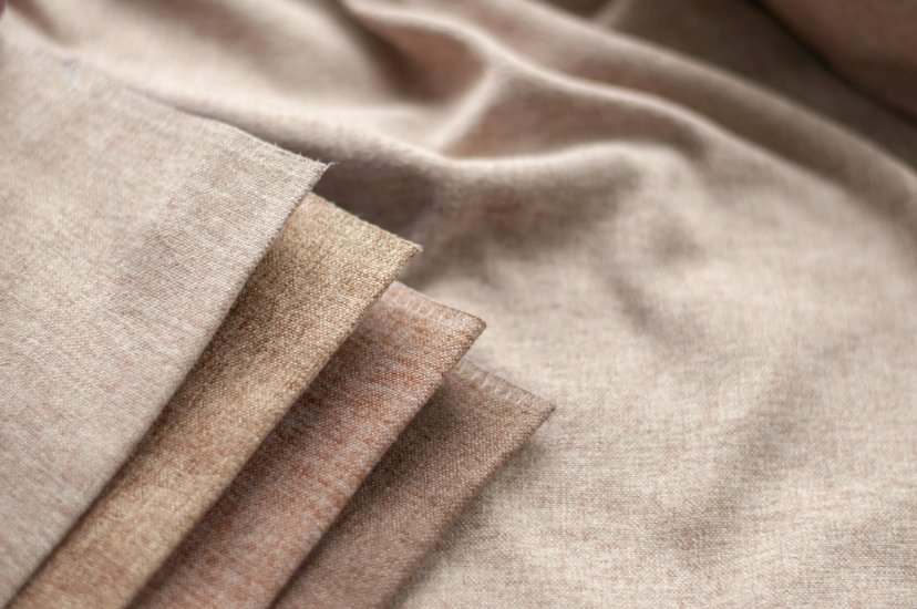 Macro shot of tightly woven linen fabric showing fine craftsmanship and texture.