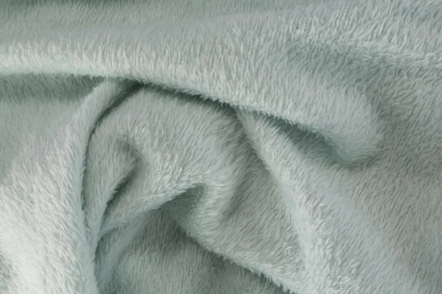 Fleece fabric showing soft polyester knit texture with warm insulating pile structure