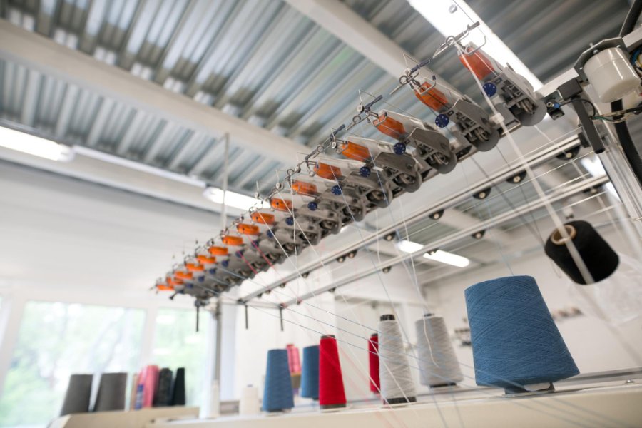 Diagram showing the production process of bio-based polyester from sugarcane to finished fabric