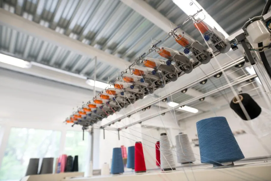 Diagram showing the production process of bio-based polyester from sugarcane to finished fabric