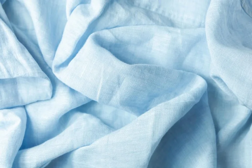 Soft light blue linen fabric with a natural texture and airy drape suitable for shirts and blouses.