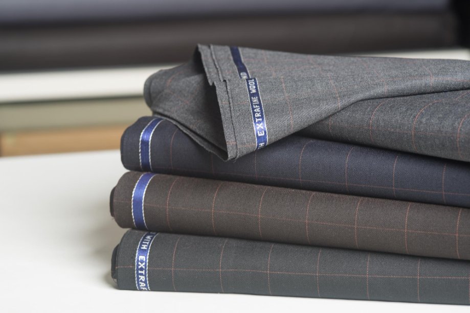Close-up image of folded linen fabric showing its fine texture and weave suitable for suiting.