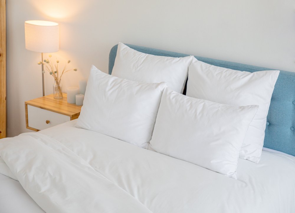 Linen fabric used in various home applications including bedding, tablecloths, curtains, and kitchen towels