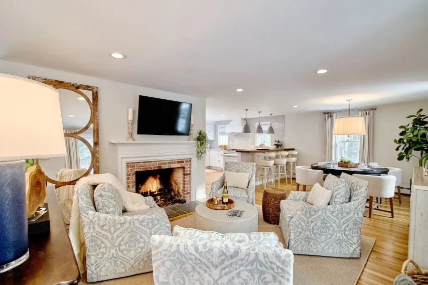 Modern living room with damask accent pillows and curtains showing balanced styling