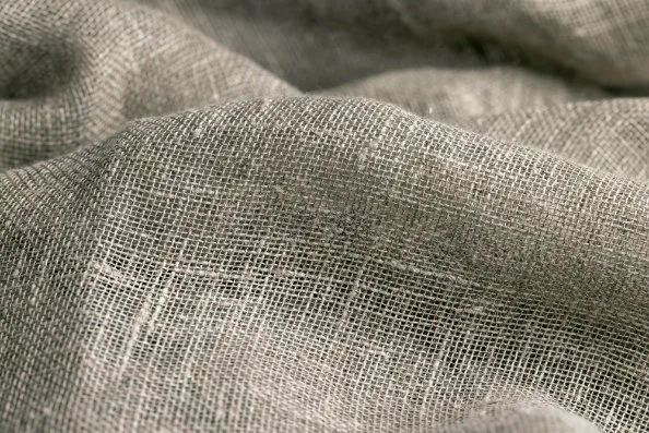 Close up view of loose weave linen fabric structure and thread spacing